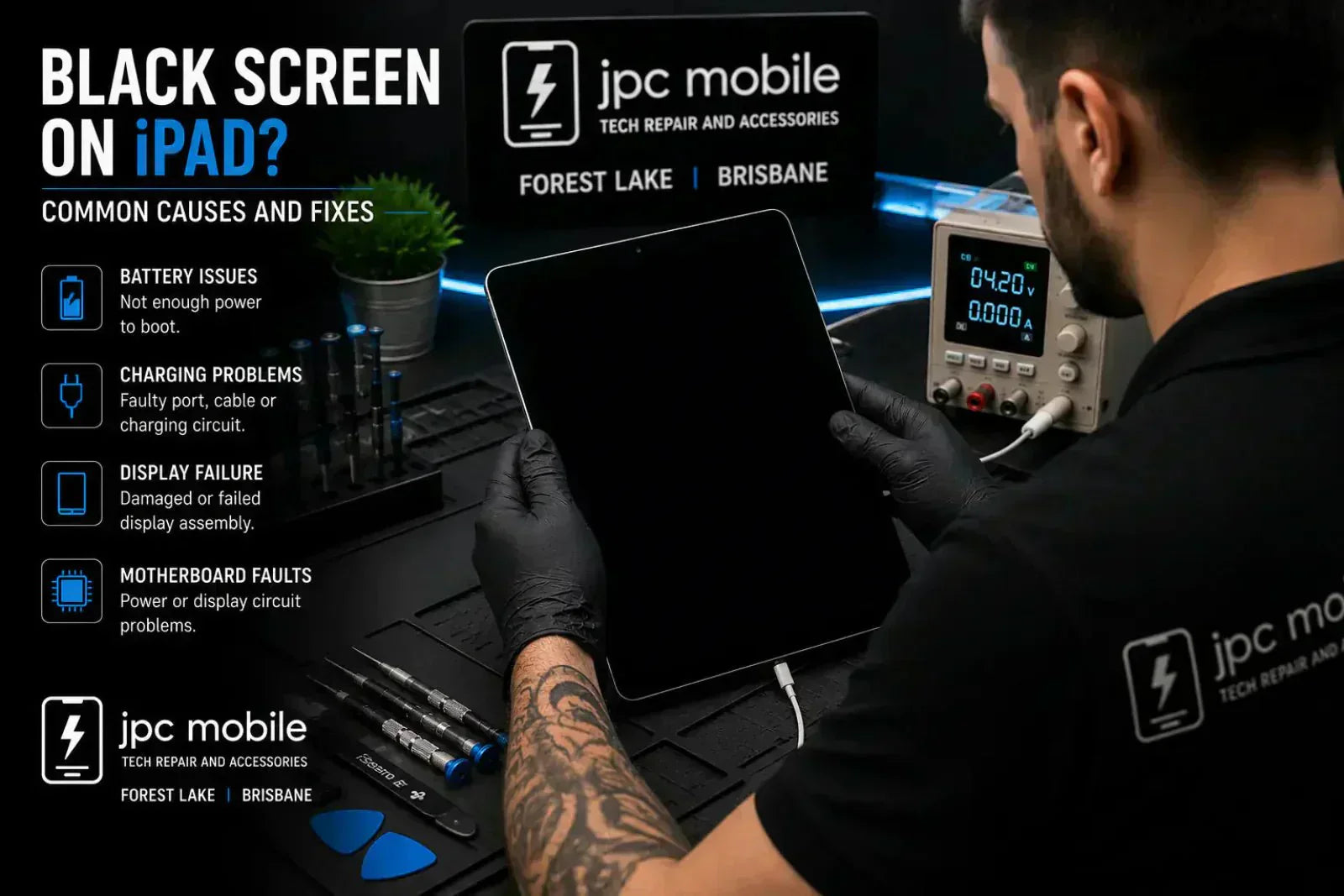 Technician diagnosing an iPad with a black screen and no display problem at a professional repair workstation