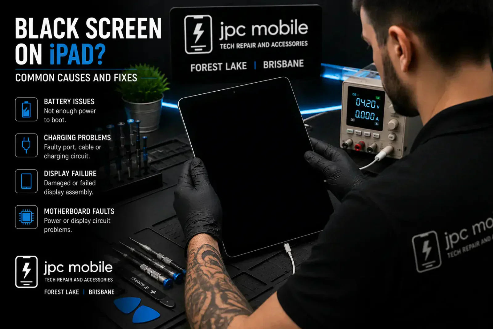 Technician diagnosing an iPad with a black screen and no display problem at a professional repair workstation