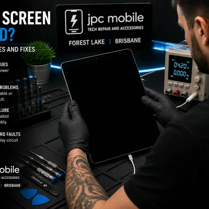 Technician diagnosing an iPad with a black screen and no display problem at a professional repair workstation