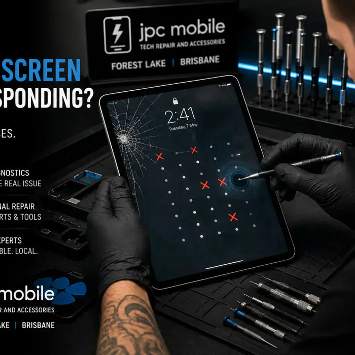 Technician diagnosing an iPad with touch screen response problems at a professional repair workstation