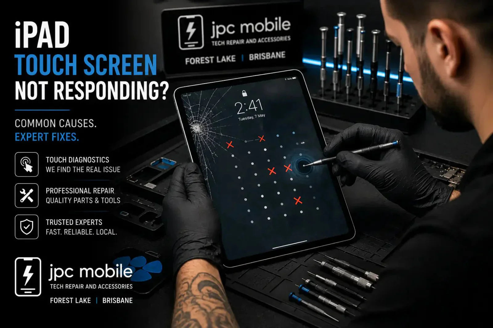 Technician diagnosing an iPad with touch screen response problems at a professional repair workstation