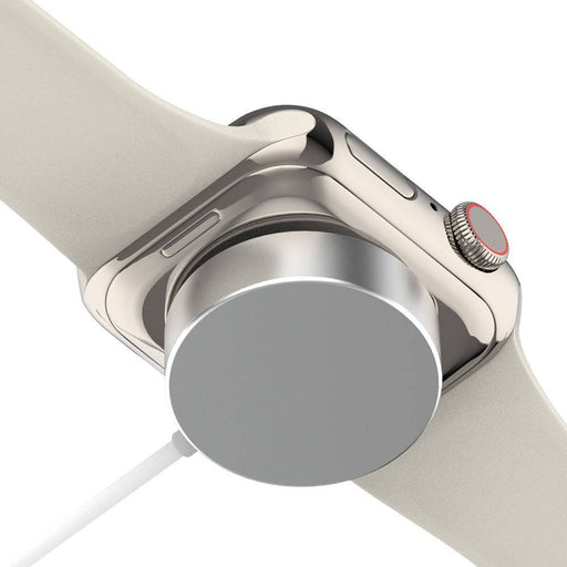 Illustrative Apple Watch resting on iQuick magnetic charging pad