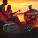 Close-up of REDEFINE PDCKET Bluetooth Portable Speaker with charging port and buttons.