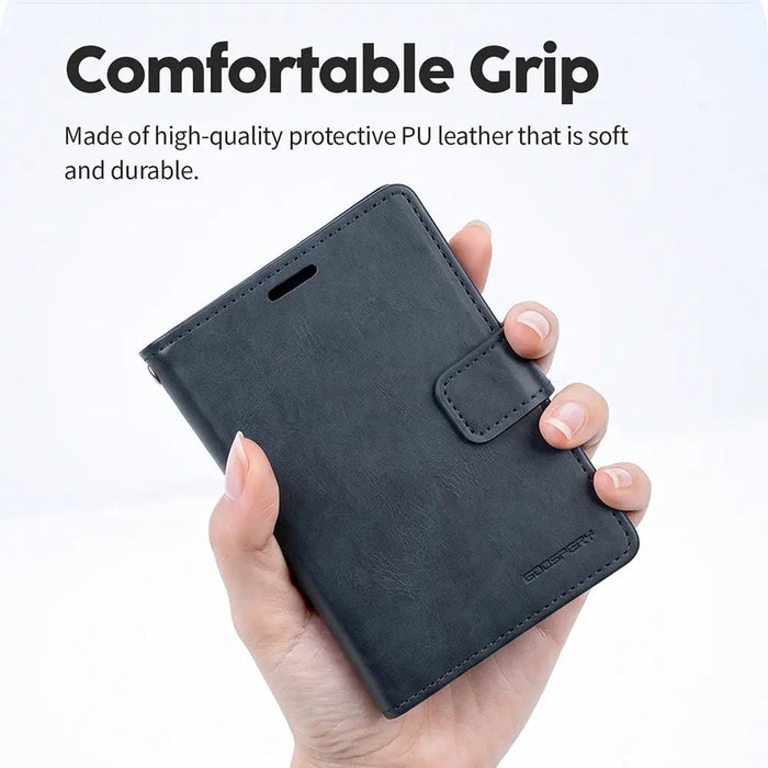 Navy Mercury Blue Moon diary-style wallet case held closed in one hand